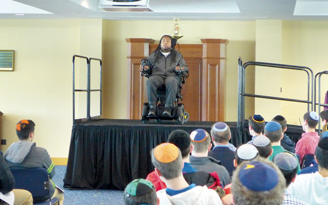 Eric LeGrand, author of “BELIEVE: My Faith and the Tackle That Changed My Life,” talks to students.