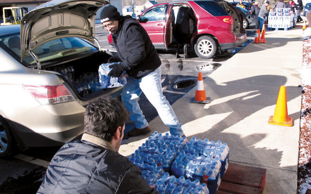 Volunteers offload bottled water donated by the Flint Jewish community to a local church as the lead crisis in the water supply continued. (Courtesy of Flint Jewish Federation)