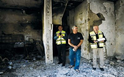 Israelis inspect the damage to a burnt house in Haifa on November 25. (Gili Yaari/Flash90)