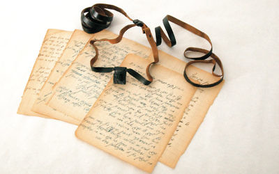 A set of tefillin and diary pages that belonged to Isaac Avigdor, a young Polish rabbi imprisoned at Mauthausen, are on display at the Amud Aish Memorial Museum. Avigdor shared the smuggled tefillin with other inmates during his imprisonment. (Courtesy of Amud Aish)