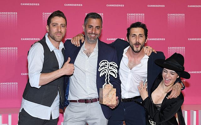 From left to right: Moshe Ashkenazi, Omri Givon, Tomer Kapon and Ninet Tayeb accept an award for best series for “When Heroes Fly” at the Canneseries festival in Cannes, France, April 11, 2018. (Pascal Le Segretain/Getty Images)