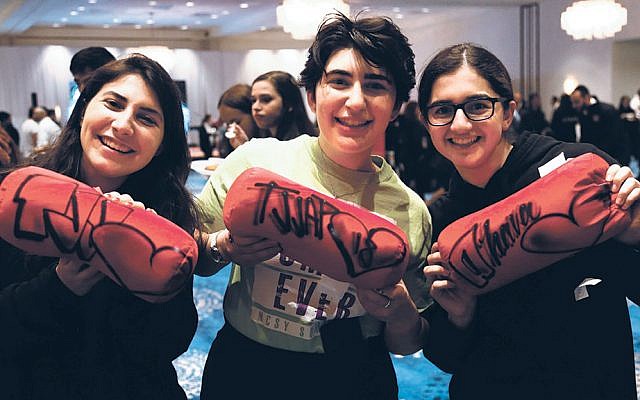 Linit, center, Stephanie, right, and a friend stand together at the convention. (Etan
 Vann/NCSY)