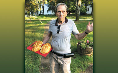 Gerard Soffian shows off the fresh-baked challah he made at Charles Rubin's challah workshop.