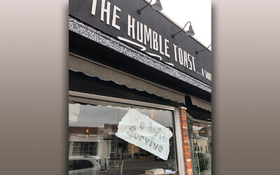 A sign of the times — this Teaneck restaurant looks forward with hope. (Jamie Janoff)