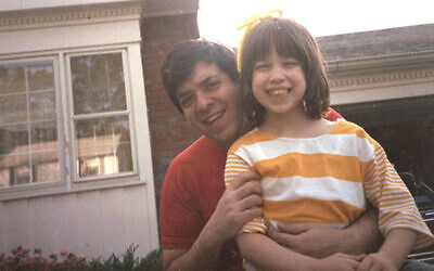 Tony Glickman holds his young daughter, Dalia.