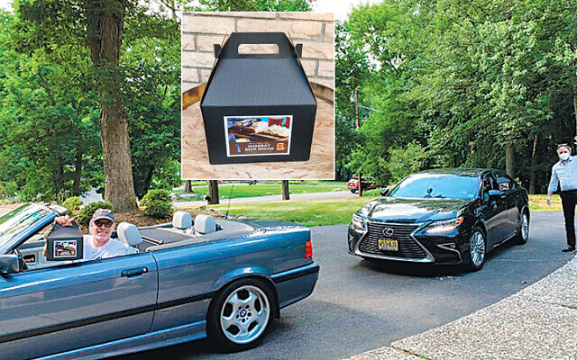Rabbi Chanoch Kaplan of the Chabad Jewish Center of NWBC — Franklin Lakes, waving, distributes the beer boxes. The congregants in the cars both are named Steve Hecht; one comes from Wyckoff and the other from Franklin Lakes. Coincidentally, they pulled in behind one another. Inset: A sample beer box. (Photos courtesy Chabad)