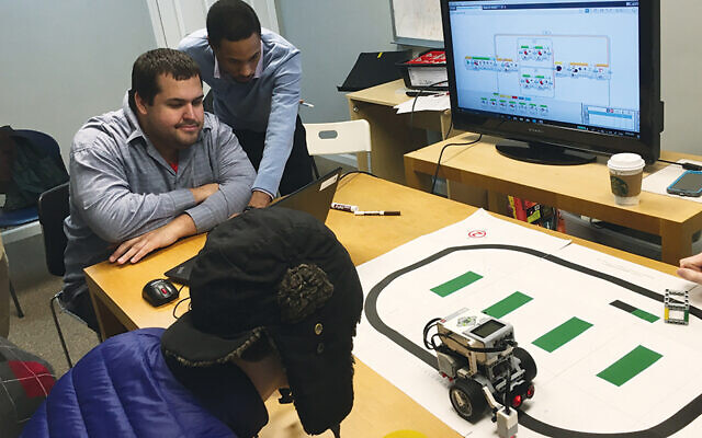 JoyDew members learn how to program a robot. JoyDew members learn how to program a robot.