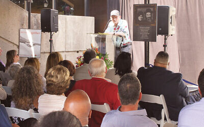Alan Moskin, a camp liberator, speaks at the opening.