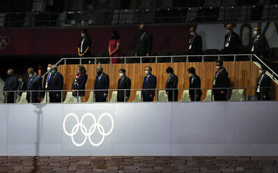 The emperor of Japan, International Olympic Committee president Thomas Bach, and others stand for a moment of silence during the opening ceremony of the Tokyo 2020 Olympic Games. (Martin Rickett/PA Images via Getty Images)