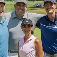 Dr. Robert Simon, Todd Forman, and and David Reichel stand behind Play Fore! The Kids Co-Chair Tracy Wolfson Reichel.