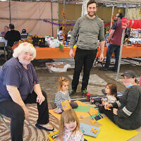 In Fair Lawn, Temple Beth Sholom’s sukkah was decorated by its members and nursery school families. Here, Cantor David Krasner, his wife Sheri, their daughters, and Carol Zuchter and her granddaughter enjoy the afternoon.  
(Courtesy Temple Beth Sholom)