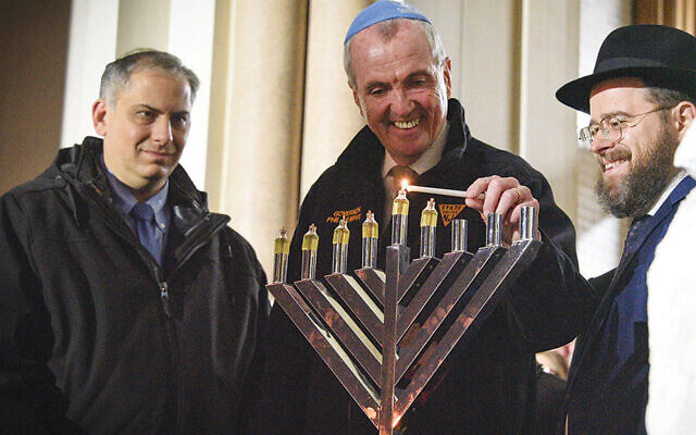 Deputy Consul General Israel Nitzan, left, with Governor Phil Murphy, and Rabbi Moshe Shapiro of Chabad of Hoboken. (Photos courtesy JFNNJ)