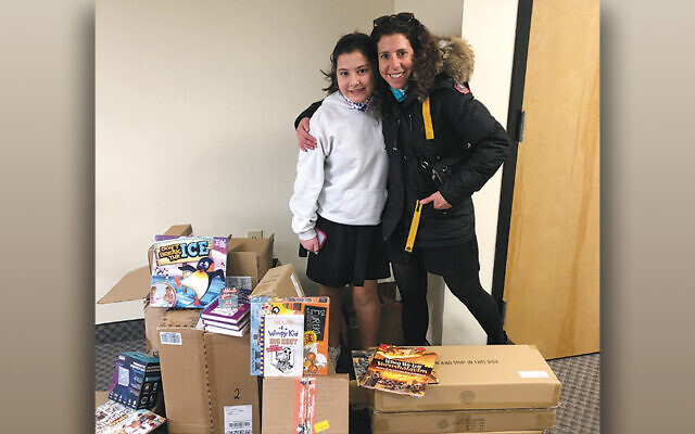 Gabby and her mother, Tamar, delivering their donated items to the SINAI Schools offices.
