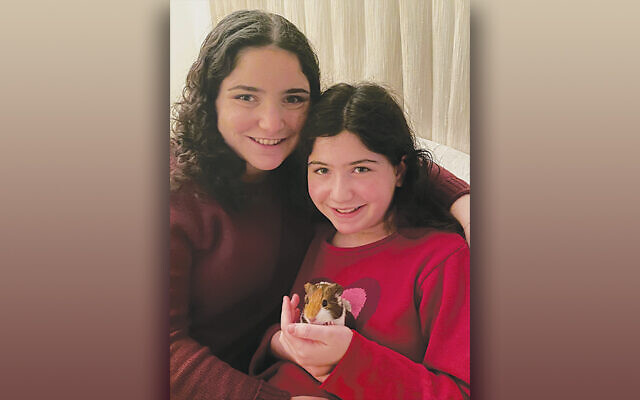 Melissa, left, and Rebecca Gotlib with their pet guinea pig, Maple.
