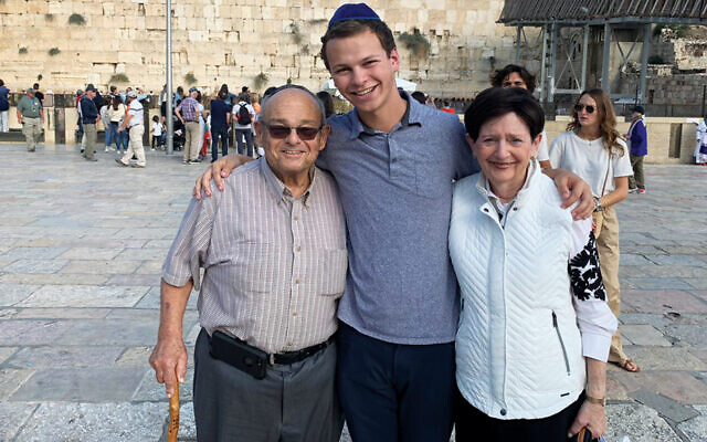 Matthew Ganchrow stands between his grandparents, Mendy and Sheila, at the Kotel in Jerusalem.