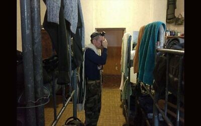 Tzvi Arieli, seen here praying in a Ukrainian army barracks in 2017, is a Ukrainian immigrant from Israel who is fighting in its army. (Courtesy Arieli)