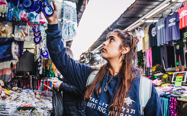 A pre-pandemic Birthright Israel participant shops in the shuk in Jerusalem’s Old City. (Birthright Israel)