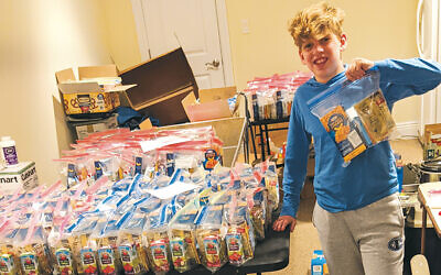 Robbie Feiler of River Vale and the hundreds of bags he packaged and distributed for his bar mitzvah project.