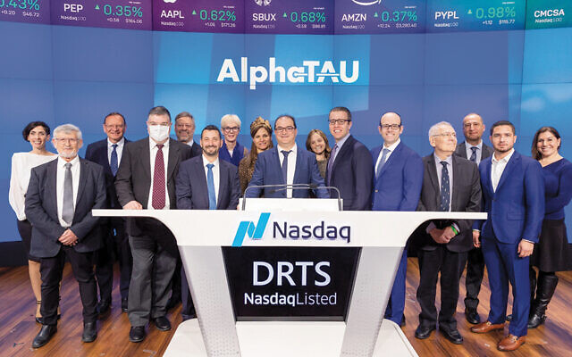 At the bell ringing for Alpha Tau Medical on March 24 at Nasdaq, CEO Uzi Sofer stands at the center of the podium, CFO Raphi Levy is immediately to the right, and VP Legal Rebecca Becker is at the far right. (Photo courtesy of Nasdaq, Inc.)