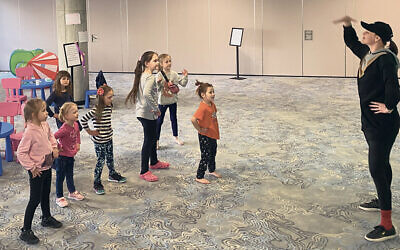 A Jewish agency volunteer teaches dance to refugee children at a Jewish Agency hotel in Warsaw.