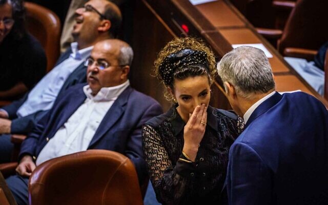 Idit Silman, member of the Yamina party, speaks to Yair Lapid, member of the Yesh Atid party, at the Knesset, in Jerusalem, June 13, 2021. (Marcus Yam/Los Angeles Times)