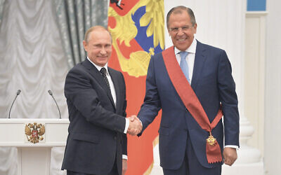 Russian Foreign Minister Sergei Lavrov, right, shakes hands with President Vladimir Putin in Moscow on May 21, 2015. (Kremlin Media Center)