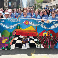 Students hold up the Frisch banner.