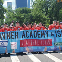 Students from the Yavneh Academy in Paramus hold the school’s banner