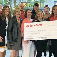Local State Farm agents present a check to JFCS