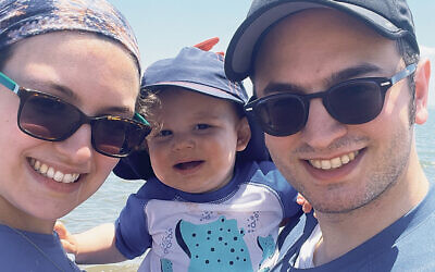 Parents Daniella and Nissan Holzer with Shlomo, 15 months old, enjoying a beach day at Midland Beach in Staten Island.