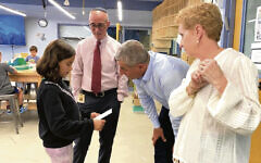 At the Solomon Schechter Day School of Bergen County, Ronen Marelly talks to a student as the head of school, Steve Freeman, and its assistant head, Ricky Stamler-Goldberg, look on.