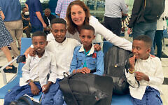 Dina Bassen stands behind four Ethiopian boys at the airport. (All photos by Jason Shames; courtesy Jewish Federation of Northern New Jersey