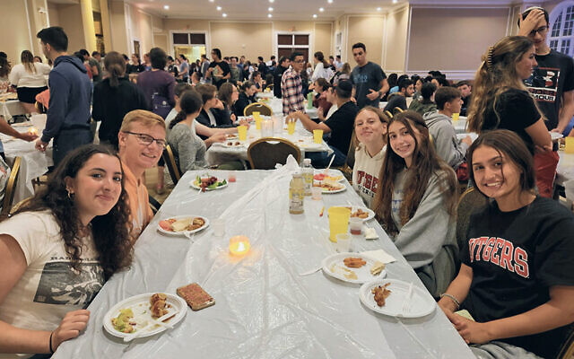 Students in the Chabad dining room sample dishes prepared  by Chabad’s new chef, Moshe Schoenfeld. (Photos courtesy Rutgers Chabad)