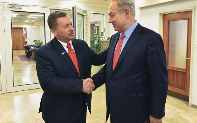 In Jerusalem, Rev. Chris Edmonds shakes hands with then Israeli Prime Minister Benjamin Netanyahu.