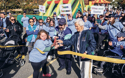 Summer Stout, Rabbi Zalman Grossbaum, and Paula Gottesman cut the ribbon to start the walk. (All photos courtesy Friendship Circle/Lifetown)