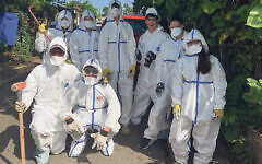 Students wear hazmat suits as they prepare to clean storm damage in Puerto Rico.