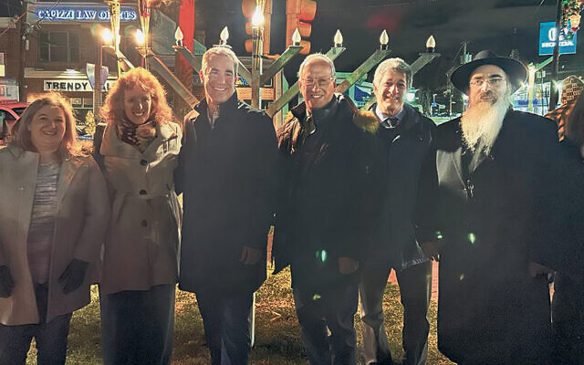 Tenafly Council members Lauren Dayton, Julie O’Connor, and Adam Michaels, left, with Mayor Mark Zinna, Councilman Jeff Grossman, and Rabbi Mordechai and Malkie Shain of Lubavitch on the Palisades. (Courtesy LOTP)