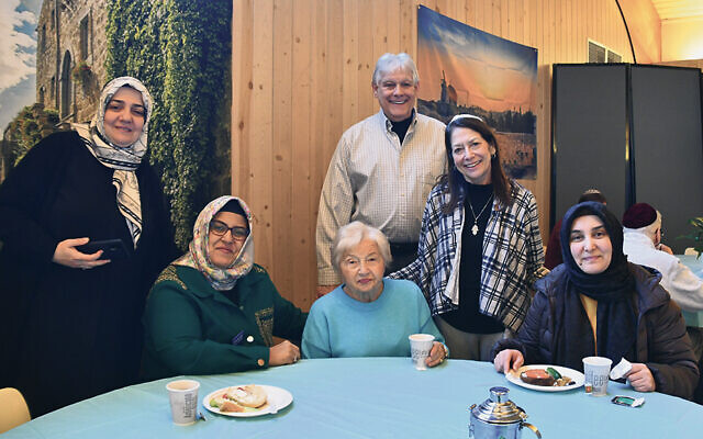 Esra Tozan, left, with other representatives from Peace Islands, and Congregation B’nai Israel congregants Hanna Wechsler — in blue, seated — and behind her, Dave and Ellen Michelson. (Courtesy CBI)
