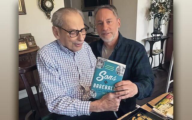 Mark Braff shows his new book to his father, Milton, who played catch with him on their Fair Lawn block. (Courtesy Mark Braff)