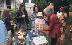 Merrill Silver cuts the cake at her backyard barbecue for some of her most recent students.