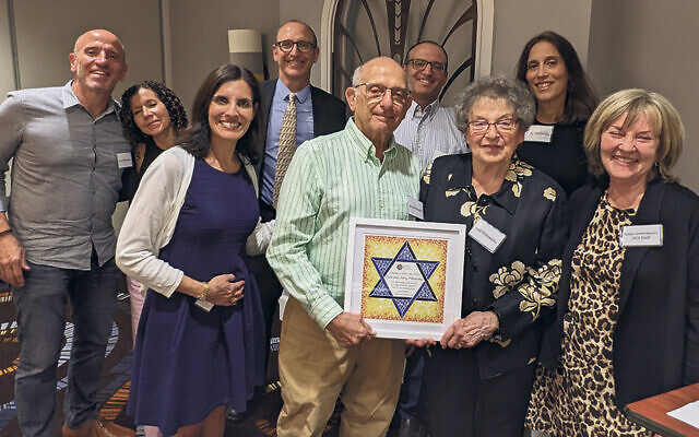 Larry and Lori Pitkowsky, back left, with Rabbi Joel Pitkowsky and Michael and Abby Pitkowsky. JFCS volunteer coordinator Stacey Frenkel, honorees Jerry and Judi Pitkowsky, and JFCS CEO Susan Greenbaum are in the front.