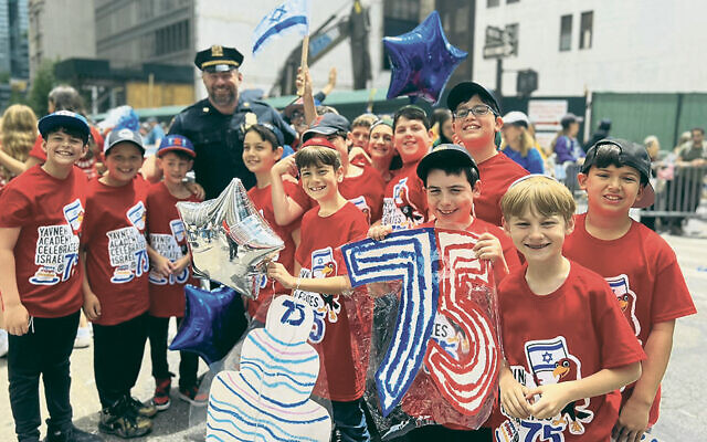 Students from the Yavneh Academy in Paramus have fun as they walk in the Celebrate Israel parade last Sunday. (Yavneh Academy)