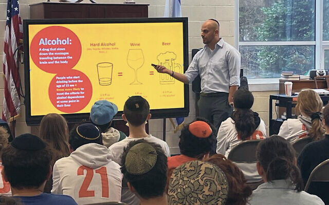 A presenter, Sam, talks about the effects of alcohol to a group of Jewish day school students.