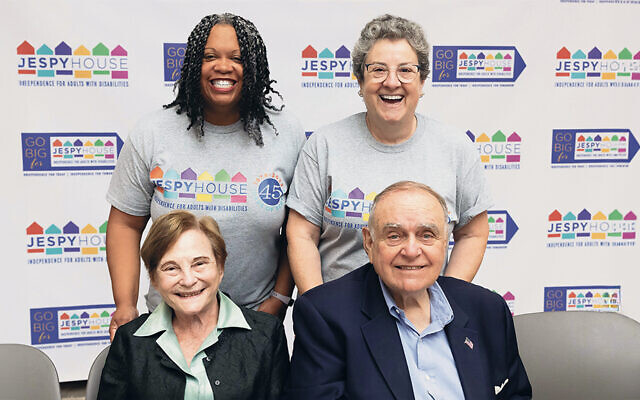 Toby and Leon Cooperman, at bottom, and JESPY’s president, Ahadi Bugg-Levine, top  left, and its executive director, Audrey Winkler, smile as the Coopermans’ matching gift is announced. (Elise Campbell Photography)