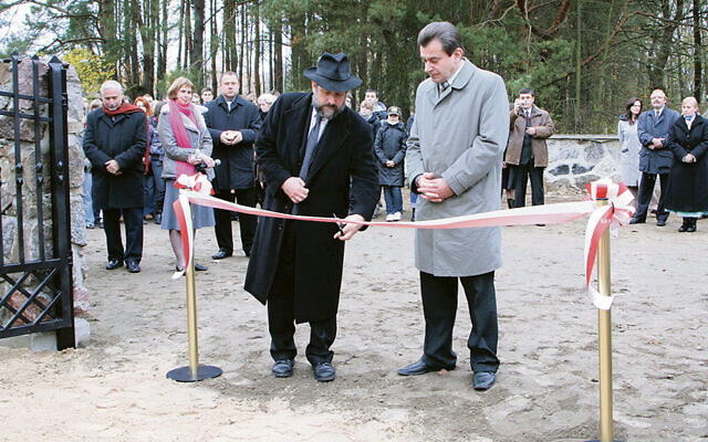 As the Jewish cemetery in Ciechanowiec is reopened in 2008, Poland’s chief rabbi, Michael Schudrich, cuts the ribbon and Mirek Reczko, then the town’s mayor, looks on.