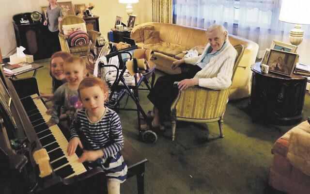 Mimi Lief of Fair Lawn  looks on with pleasure as some of her  great 
grandchildren play piano — or  more accurately, play at playing the piano.