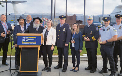 Sarah McCain, who ran the program, is pictured center. Next to her, far left are Rabbis Avremy Kanelsky and Mordechai Kanelsky, surrounded by Port Authority of New York and New Jersey police and employees. (Courtesy Bris Avrohom)
