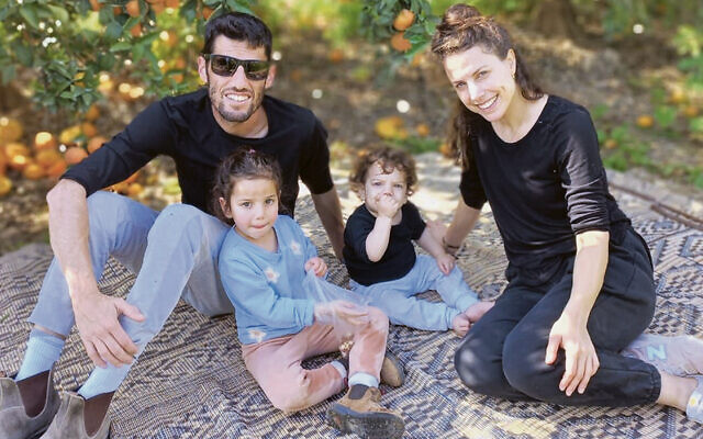 Shahar Tzemach, sitting here with his young family, was murdered as he defended his kibbutz.