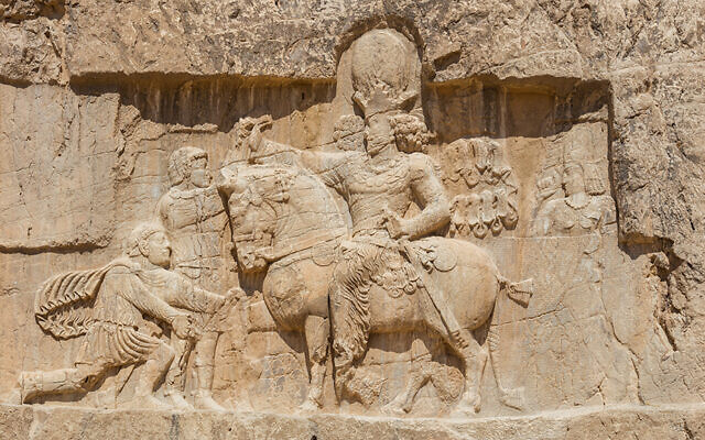 This relief of triumph of Shapur I over Valerian at Naqsh-e Rostam (ca. 241–272 CE), shows the Roman Emperor, Valerian, kneeling before Shapur I, asking for mercy. The Emperor Philip the Arab is standing, and Gordian III is dead at the feet of Shapur’s horse. (Wikipedia/Diego Delso)