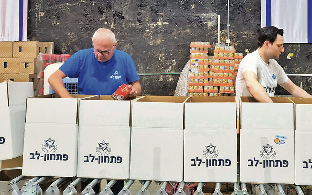 Eytan Stern Weber, right, packs boxes for Pitchon Lev.